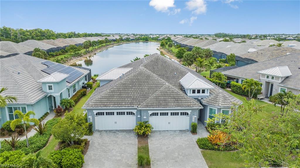 5764 Elbow Avenue Naples, FL 34113 - Photo 41 of 48 an aerial view of a house with a yard and lake view