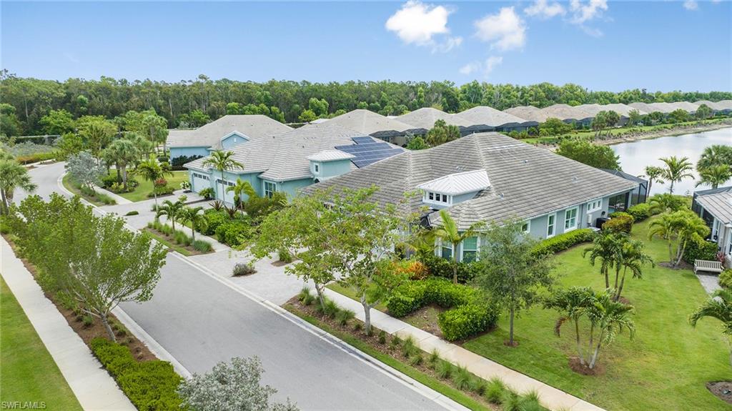 5764 Elbow Avenue Naples, FL 34113 - Photo 47 of 48 a view of a garden with a lake
