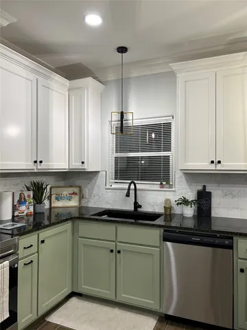 a kitchen with granite countertop white cabinets and white stainless steel appliances