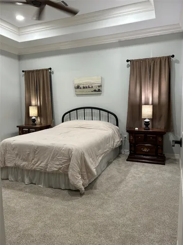 a bedroom with a bed and a television