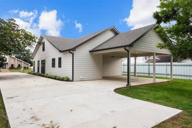 a view of a house with a patio and a yard