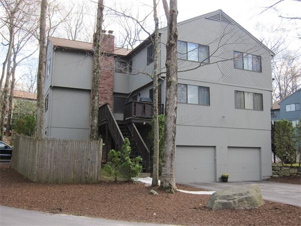 77 Mountain Gate Road, Unit 77 Ashland, MA 01721 - Photo 1 of 20 a view of a white house with a tree and wooden fence