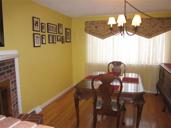 77 Mountain Gate Road, Unit 77 Ashland, MA 01721 - Photo 13 of 20 a view of a dining room with furniture a chandelier and wooden floor