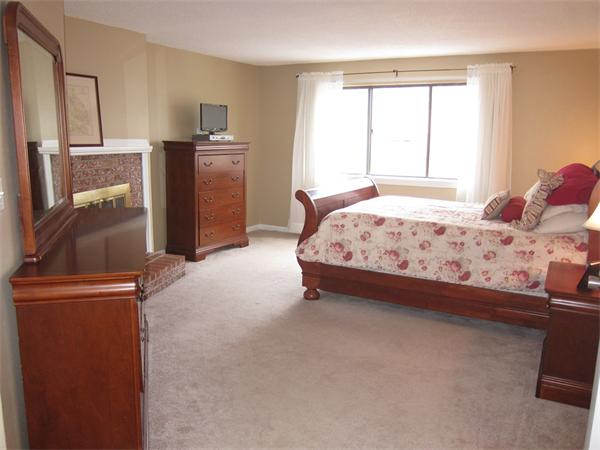 77 Mountain Gate Road, Unit 77 Ashland, MA 01721 - Photo 15 of 20 a bedroom with a bed and a television