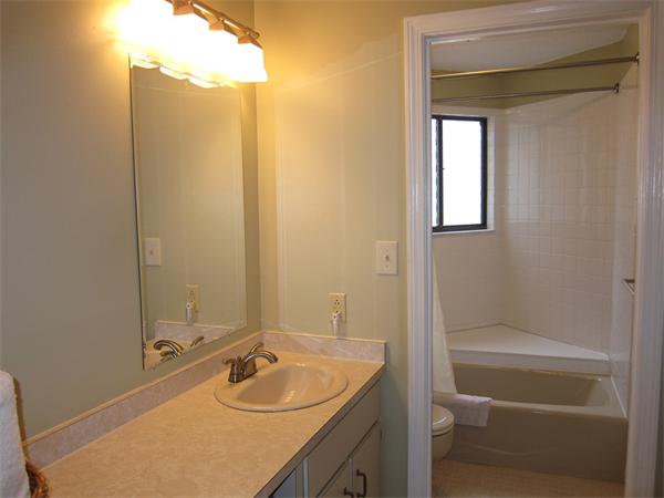 77 Mountain Gate Road, Unit 77 Ashland, MA 01721 - Photo 17 of 20 a bathroom with a granite countertop sink and a mirror