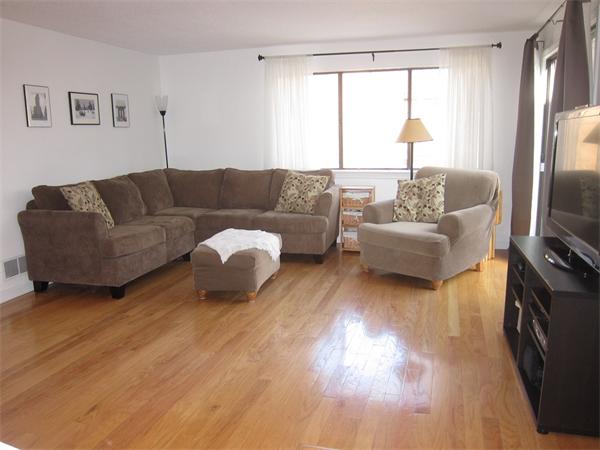 77 Mountain Gate Road, Unit 77 Ashland, MA 01721 - Photo 3 of 20 a living room with couches a coffee table and a flat screen tv