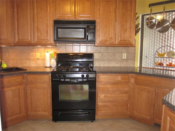 77 Mountain Gate Road, Unit 77 Ashland, MA 01721 - Photo 7 of 20 a kitchen with granite countertop cabinets stainless steel appliances and a counter space