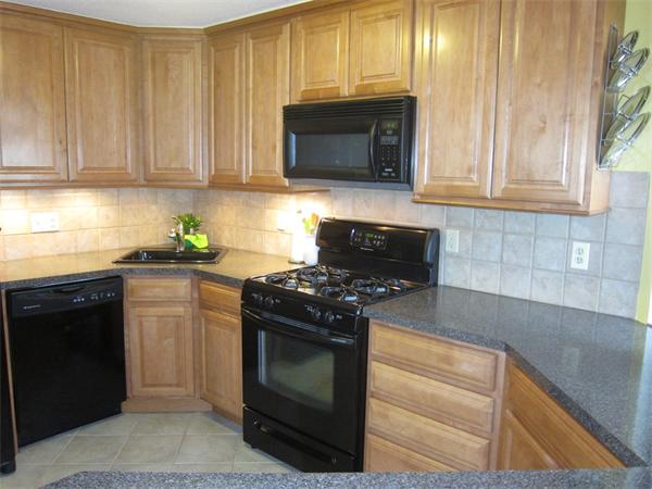 77 Mountain Gate Road, Unit 77 Ashland, MA 01721 - Photo 8 of 20 a kitchen with granite countertop white cabinets and stainless steel appliances