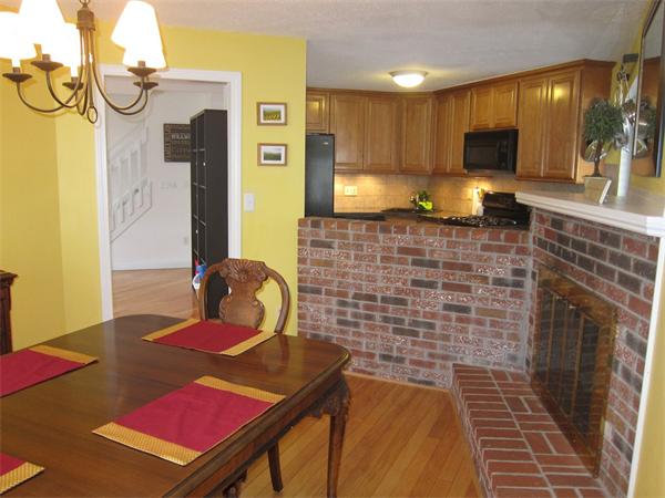 77 Mountain Gate Road, Unit 77 Ashland, MA 01721 - Photo 10 of 20 a living room with a sink and a fireplace