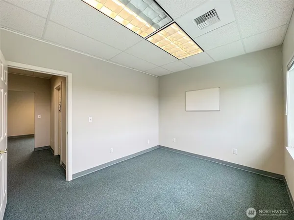 an empty room with a empty space and windows