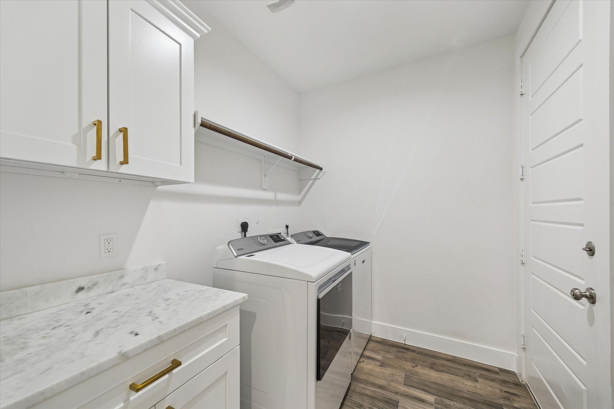 203 Hampton Glen Road Montgomery, TX 77356 - Photo 26 of 35 This utility/laundry room is both spacious and refined, featuring beautiful marble surfaces along with ample storage and counter space, perfect for organizing cleaning products, folding laundry, and hanging delicate items. Thoughtfully designed, it provides everything a family needs while maintaining a clean, polished, and functional environment.