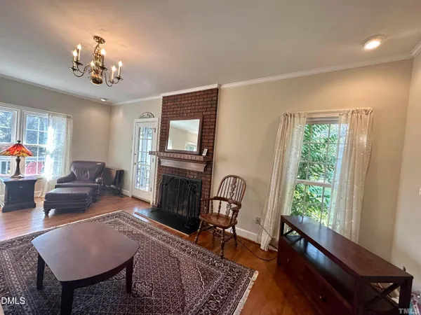 a living room with furniture a window and a fireplace