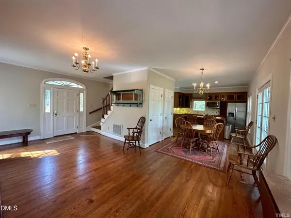 a view of a dining room with furniture and wooden floor