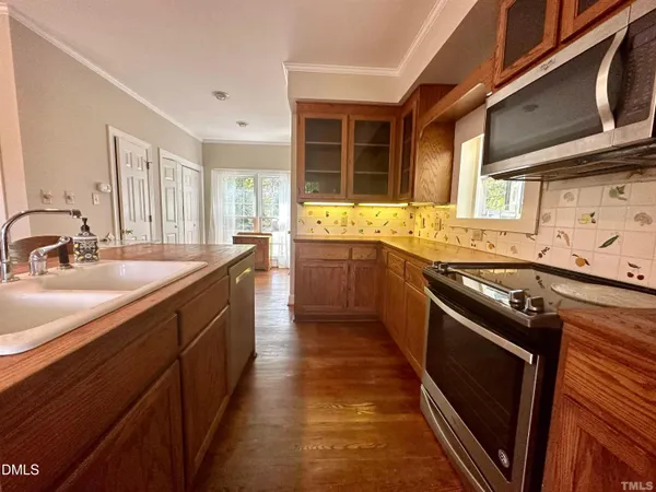 a kitchen with stainless steel appliances granite countertop a sink and stove