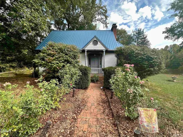 a view of a house with a yard and plants