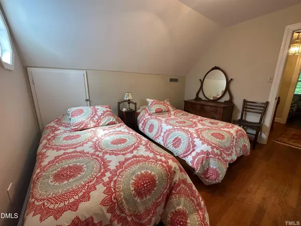 a bedroom with two beds and a dresser