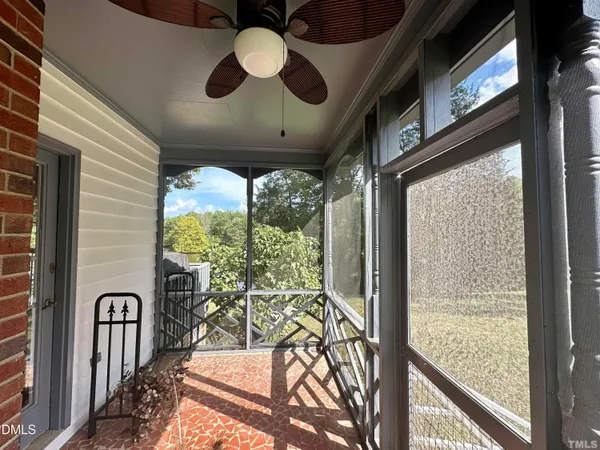 a view of a porch with furniture and garden