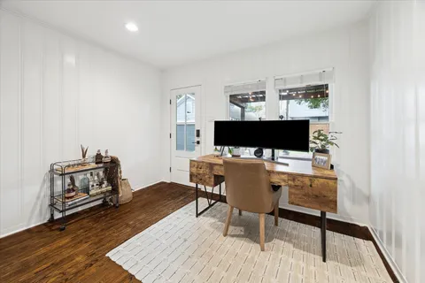 a living room with furniture a flat screen tv and a table