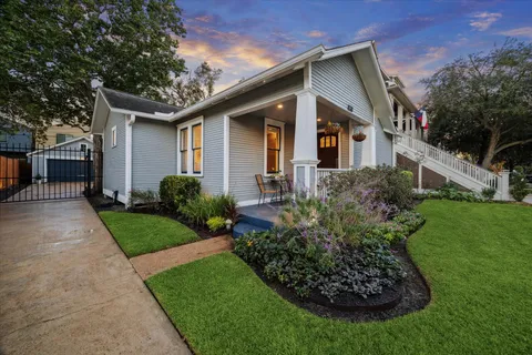 a front view of a house with a garden