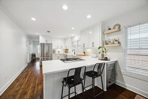 a large kitchen with a table and chairs