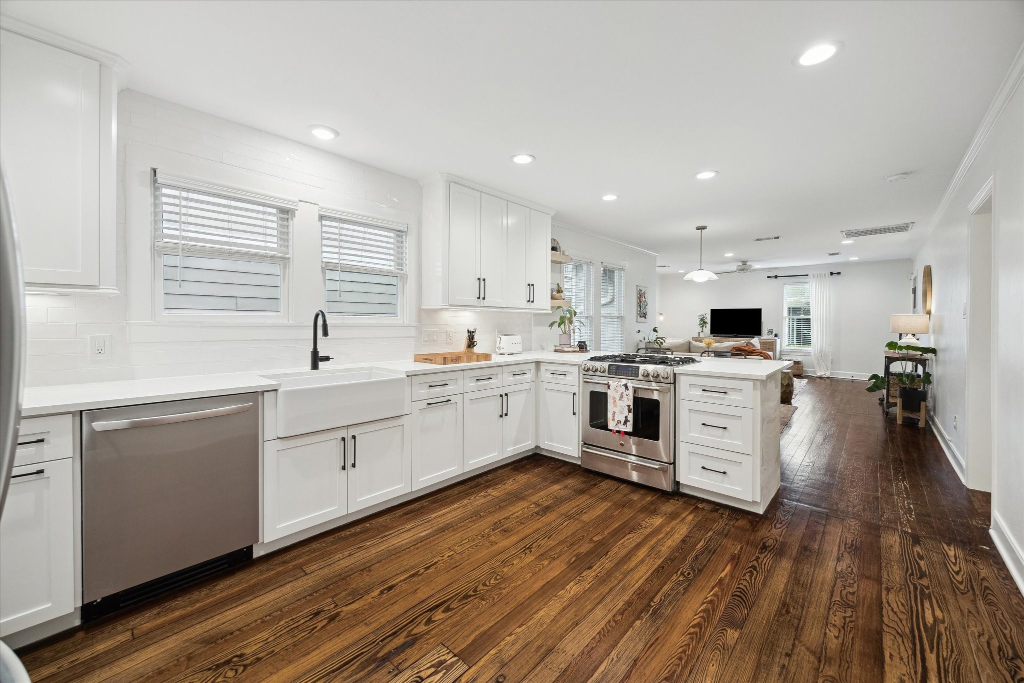 838 East 24th Street Houston, TX 77009 - Photo 9 of 28 a kitchen with white cabinets stainless steel appliances and sink