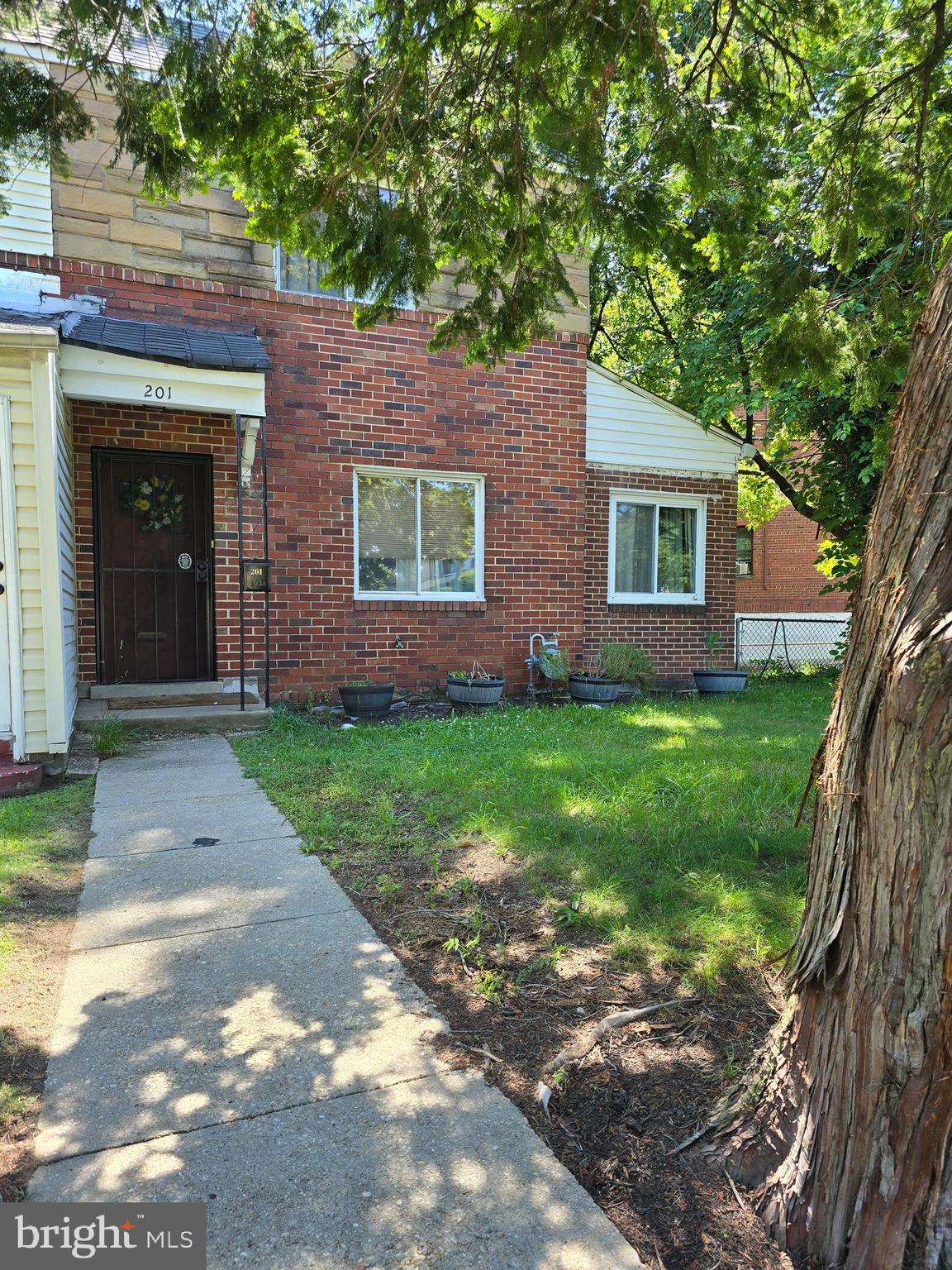 201 34th Street Northeast Washington, DC 20019 - Photo 1 of 13 a front view of a house with a garden
