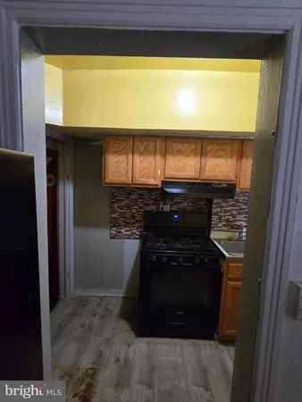 a kitchen with a stove and a refrigerator