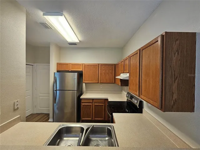 a kitchen with a refrigerator and a sink