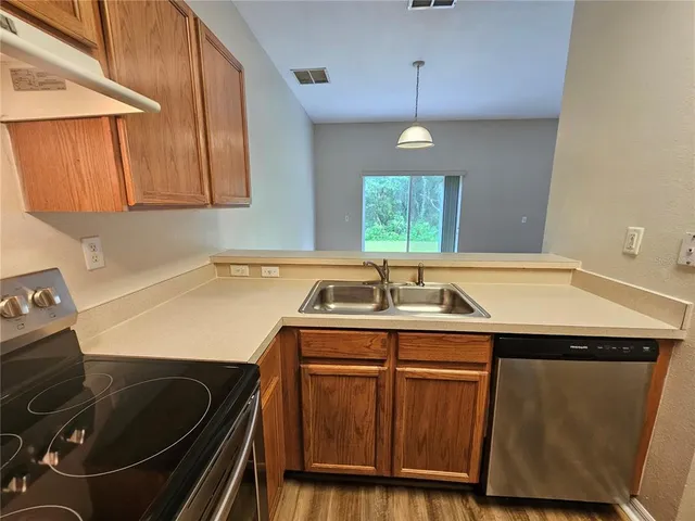 a kitchen with a sink appliances and cabinets