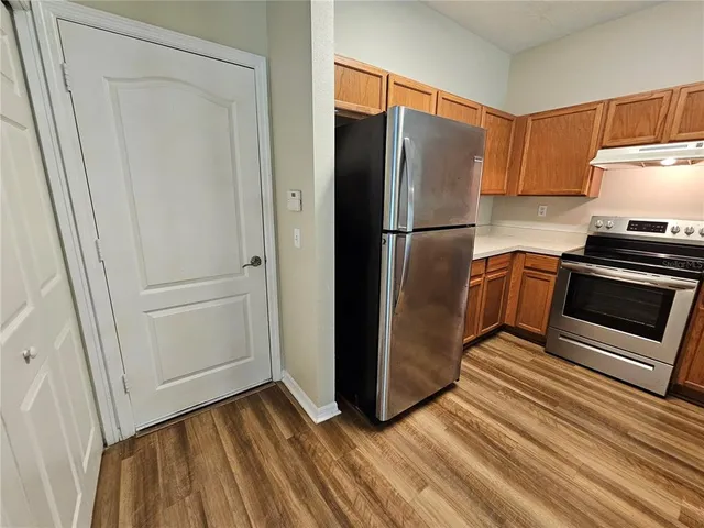 a kitchen with a refrigerator and a sink