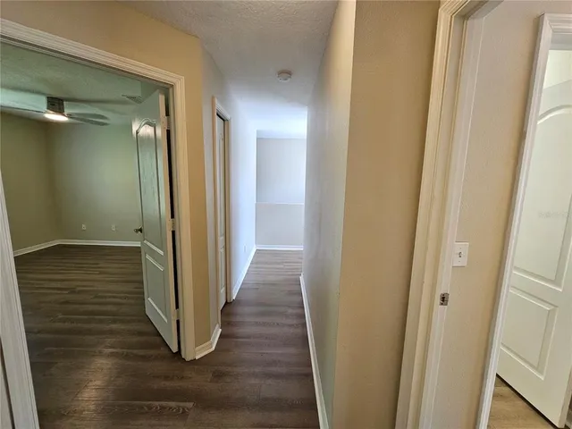 a view of a hallway with wooden floor