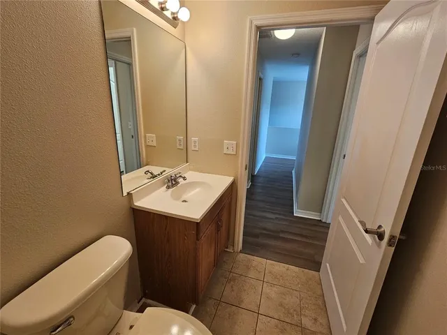 a bathroom with a sink a toilet and mirror