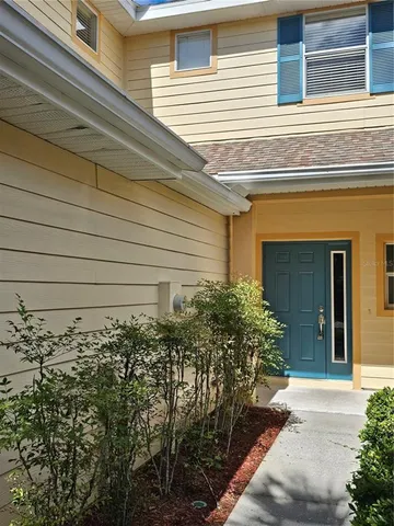 a view of a house with potted plants