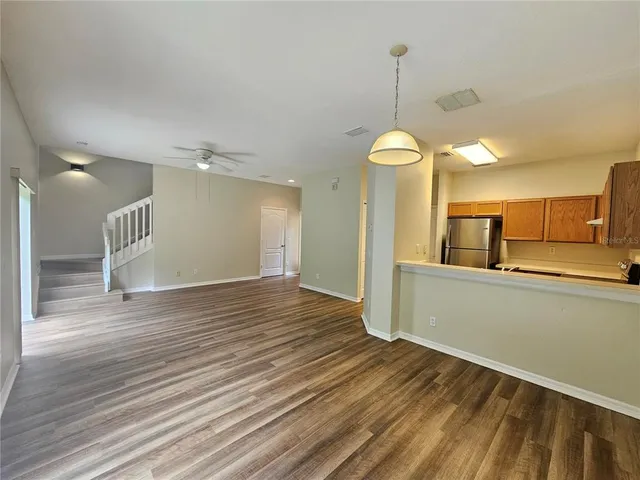 a view of a room with wooden floor and a window