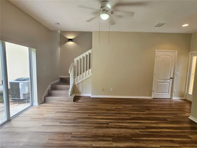 a view of entryway and hall with wooden floor