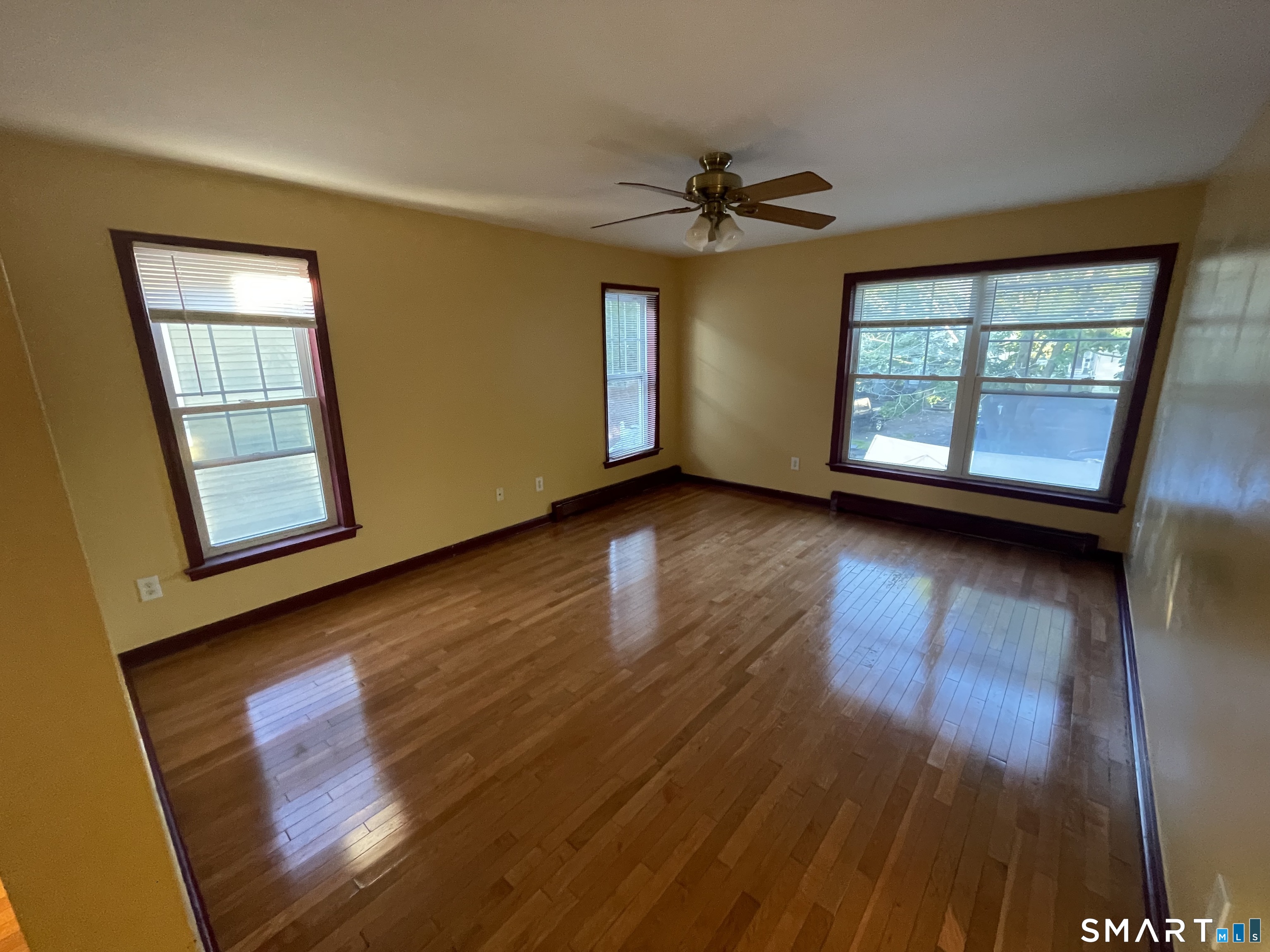11 Button Street New Haven, CT 06519 - Photo 8 of 18 a view of empty room with wooden floor and fan