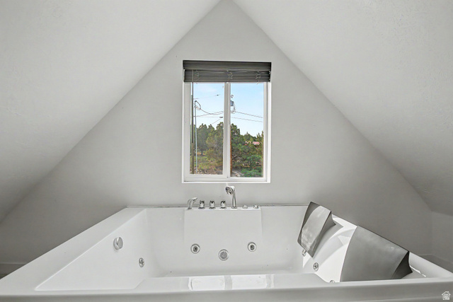 12645 East Cedar Ridge Drive Fairview, UT 84629 - Photo 17 of 34 Soaking tub featuring multiple jets, chrome fixtures, and a window with horizontal blinds