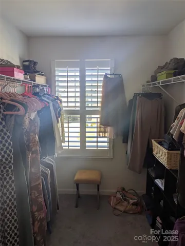 a bedroom with furniture and a window