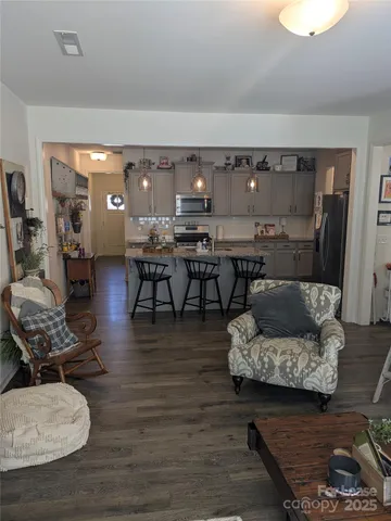 a living room with furniture and wooden floor