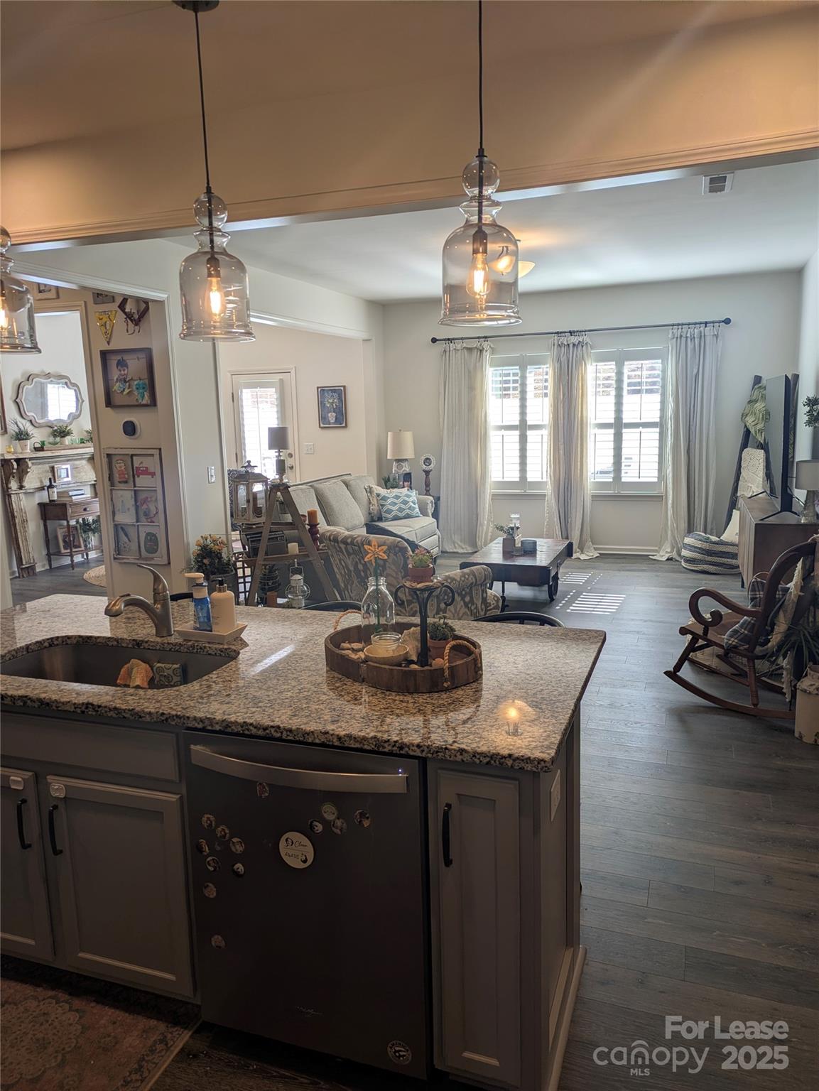 7481 Hartsfield Drive Lancaster, SC 29720 - Photo 5 of 27 a kitchen with stainless steel appliances granite countertop a sink a stove and a wooden floors