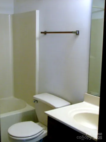 a white toilet and a shower curtain