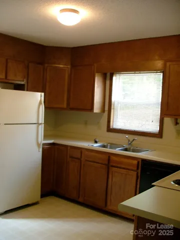 a kitchen with a sink window and cabinets