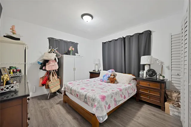 a bedroom with bed and a closet