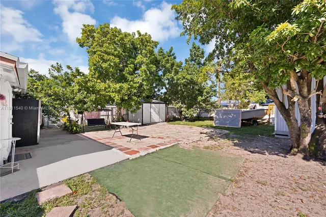 a view of a backyard with sitting area