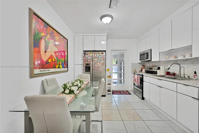 a kitchen with stainless steel appliances granite countertop a refrigerator and a stove top oven