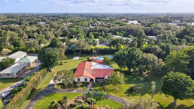 an aerial view of a house with a lake view