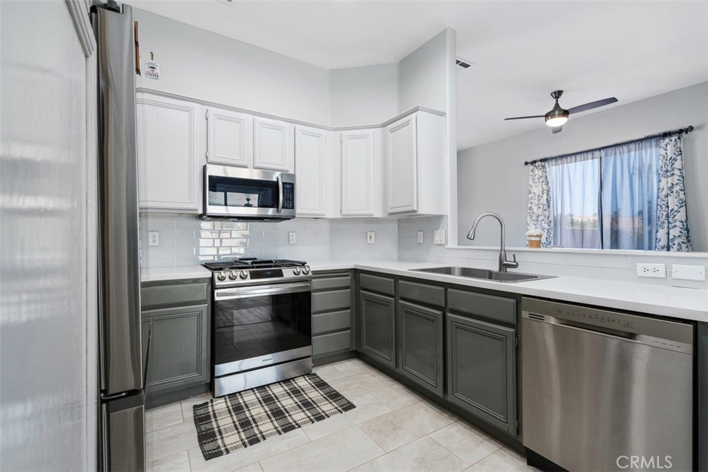68262 Pasada Road Cathedral City, CA 92234 - Photo 11 of 27 a kitchen with stainless steel appliances granite countertop a sink and a stove