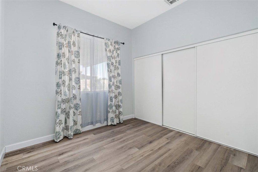 68262 Pasada Road Cathedral City, CA 92234 - Photo 17 of 27 a view of empty room with wooden floor and fan