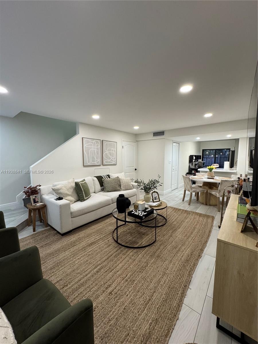 10069 Southwest 77th Court Miami, FL 33156 - Photo 2 of 16 a living room with furniture kitchen view and a couch
