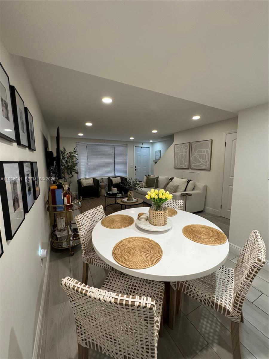 10069 Southwest 77th Court Miami, FL 33156 - Photo 9 of 16 a kitchen with a table chairs and a refrigerator